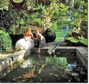 Bride and groom at the garden pond